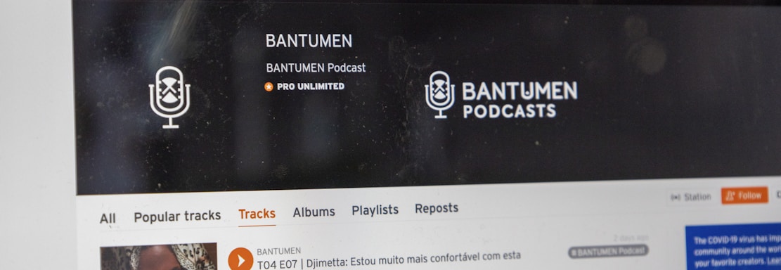 A computer screen displaying a website of an audio streaming service. The website showcases a podcast called BANTUMEN with the description 'Pro Unlimited.' There is a navigation bar with options including Home, Stream, Library, and more. A music wave graphic is visible below, along with a play button, social media interaction options such as re-post, share, and add to playlists. A banner at the top talks about fan-powered royalties, and there is a COVID-19 information widget to the side.